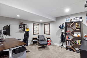 Carpeted home office featuring baseboards and recessed lighting