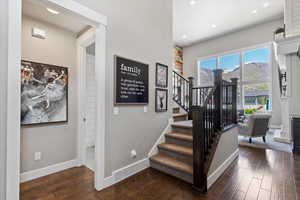 Stairs with recessed lighting, visible vents, baseboards, and hardwood / wood-style flooring