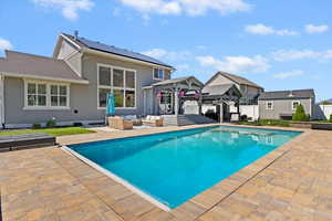 View of swimming pool with an outdoor living space, a gazebo, a patio area, and a fenced in pool