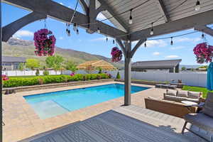 View of pool featuring a fenced backyard and a mountain view