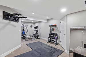 Workout room featuring carpet flooring, baseboards, and recessed lighting