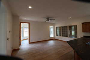 Interior space featuring recessed lighting, baseboards, a ceiling fan, and wood finished floors