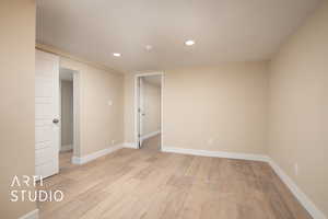 Spare room with light wood-style flooring, baseboards, and recessed lighting