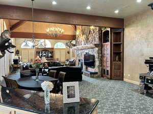 Carpeted living room with recessed lighting, baseboards, an inviting chandelier, arched walkways, and a textured wall