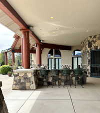 View of patio / terrace with area for grilling, french doors, and outdoor wet bar