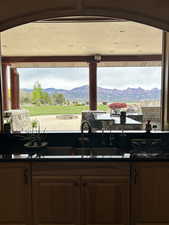 Kitchen with a sink, dark countertops, and a mountain view
