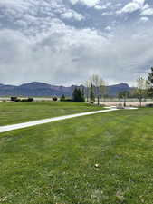 View of community featuring a lawn and a mountain view