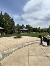 View of property's community with a gazebo and a lawn