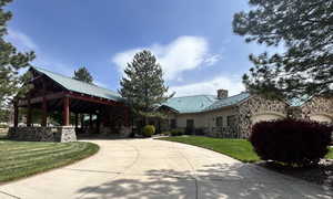 View of community with a garage, a gazebo, and a lawn