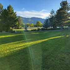 View of home's community featuring a mountain view and a yard