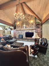 Living area with beam ceiling, high vaulted ceiling, a fireplace, a chandelier, and wooden ceiling