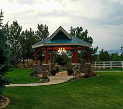 Exterior space with a yard, a gazebo, and fence