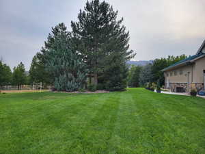 View of yard featuring a mountain view and fence