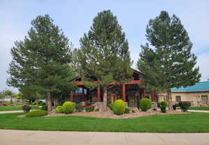 View of front facade with a front lawn and stone siding