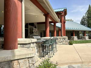 View of patio featuring an outdoor kitchen and outdoor wet bar