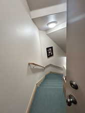 Stairway featuring carpet and baseboards