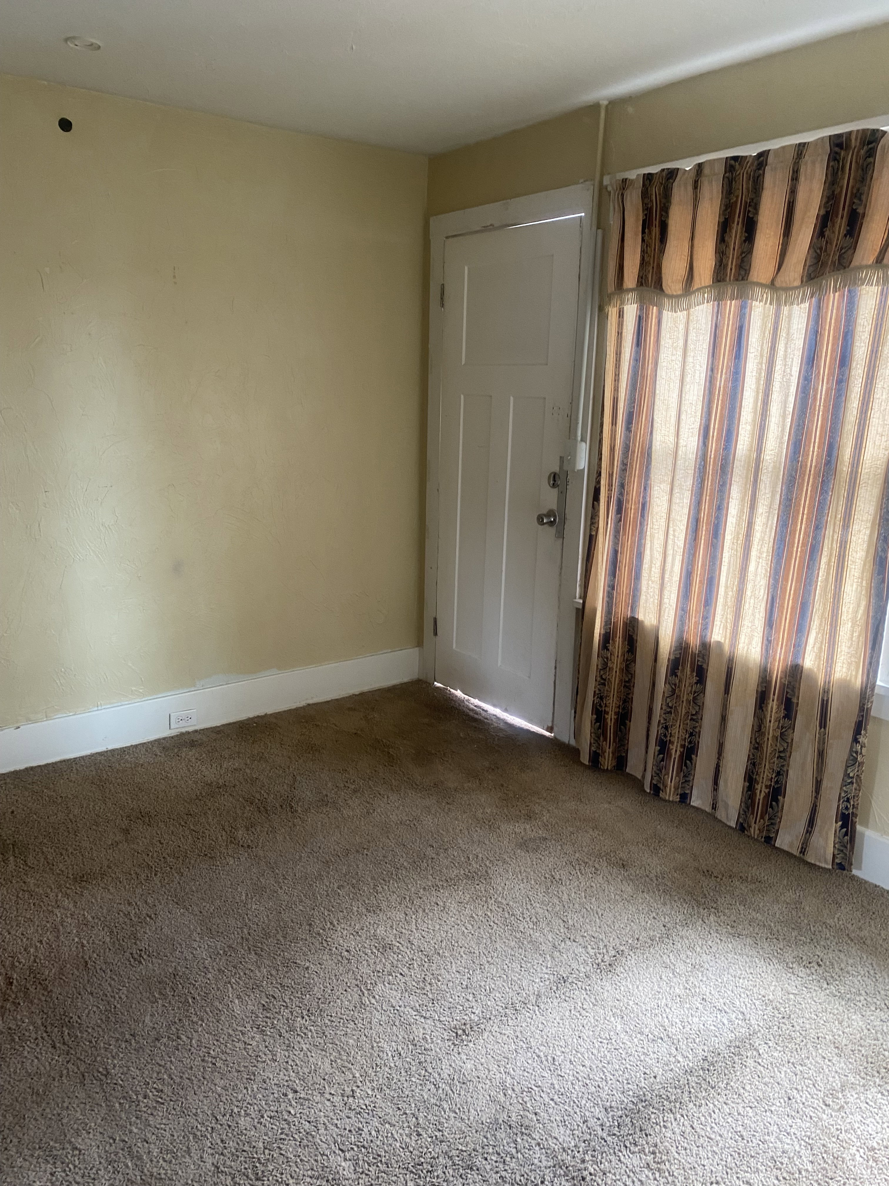Spare room with baseboards and carpet floors