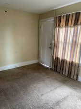 Spare room with baseboards and carpet floors