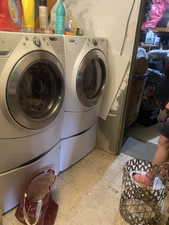 Clothes washing area featuring laundry area and independent washer and dryer