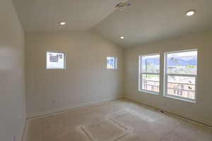 Empty room with baseboards, recessed lighting, visible vents, and vaulted ceiling