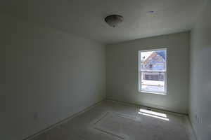 Spare room featuring visible vents and baseboards