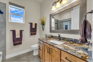 Bathroom with vanity, curtained shower, toilet, baseboards, and tile patterned floors