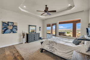 Bedroom featuring visible vents, access to exterior, baseboards, recessed lighting, and a tray ceiling