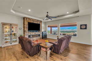 Living room featuring hardwood / wood-style flooring and a raised ceiling