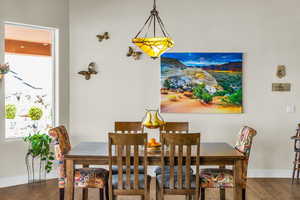 Dining area with baseboards and wood finished floors
