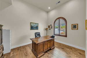 Home office featuring recessed lighting, baseboards, light wood finished floors, and visible vents