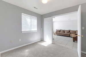 Interior space featuring baseboards, visible vents, and tile patterned floors