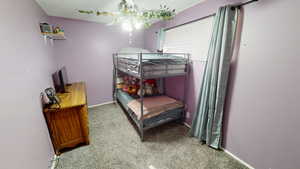 Carpeted bedroom with baseboards