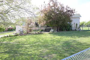 View of yard with stairway and fence