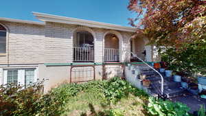 Property entrance featuring covered porch and brick siding