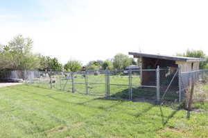 View of yard featuring a gate and fence
