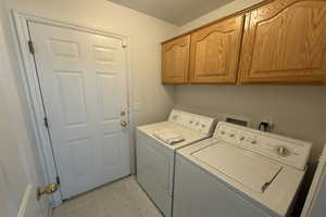 Laundry room featuring washing machine and dryer and cabinet space