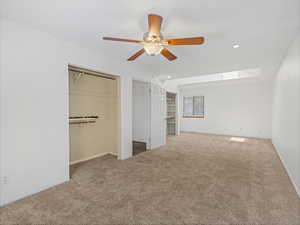 Unfurnished bedroom with baseboards, a skylight, recessed lighting, and carpet