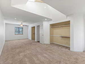 Unfurnished bedroom with two closets, carpet floors, baseboards, and recessed lighting