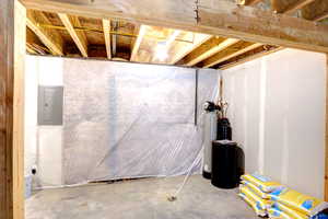 Unfinished below grade area featuring electric panel