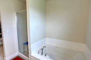 Bathroom with a garden tub and a shower stall