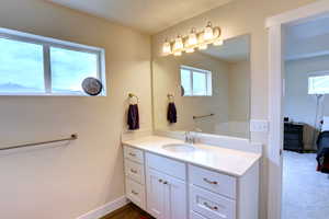 Bathroom featuring baseboards and vanity