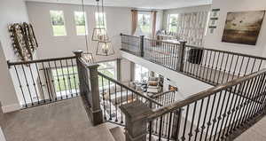 Stairs featuring carpet flooring, baseboards, a notable chandelier, and recessed lighting