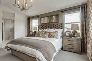 Bedroom featuring a chandelier, multiple windows, light carpet, and lofted ceiling