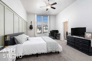 Bedroom with ceiling fan and light carpet