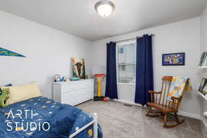 Bedroom featuring carpet flooring, baseboards, and visible vents