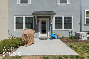 Entrance to property with a patio area and stucco siding