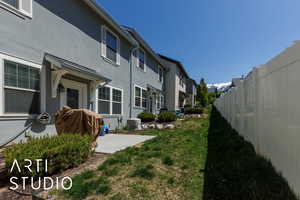 View of yard featuring fence private yard, a patio, central AC, and a residential view