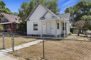Bungalow featuring fence private yard, a gate, and roof with shingles