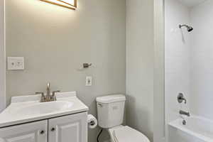 Full bathroom featuring vanity, toilet, and  shower combination
