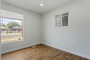 Spare room with recessed lighting, baseboards, visible vents, and wood finished floors